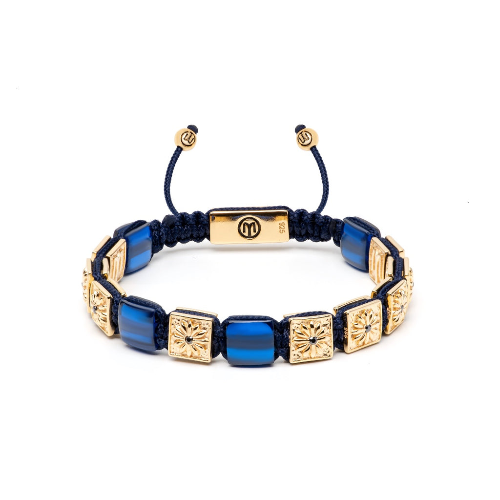 gold macramé flat-bead bracelet with navy blue string and blue sapphires on a white background - the noble 