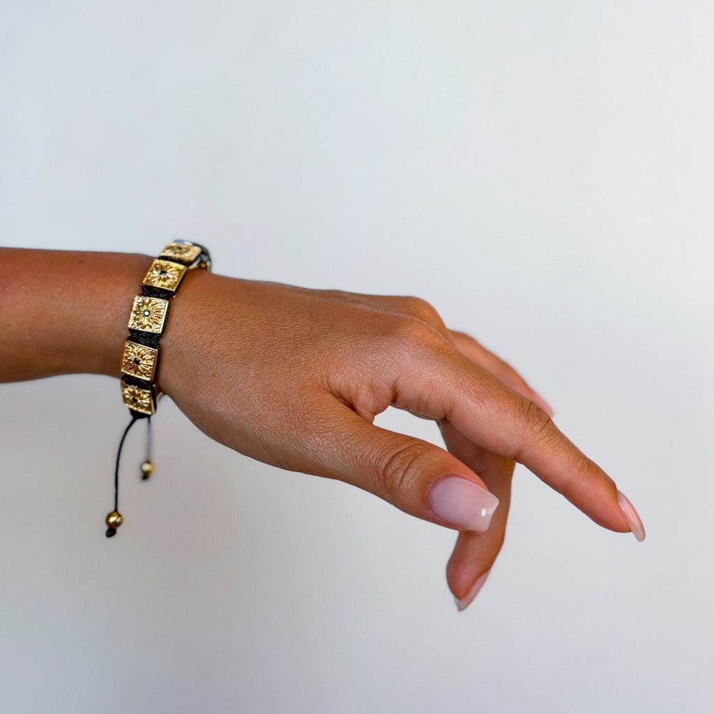 woman's hand with gold macrame bracelet - the guardian