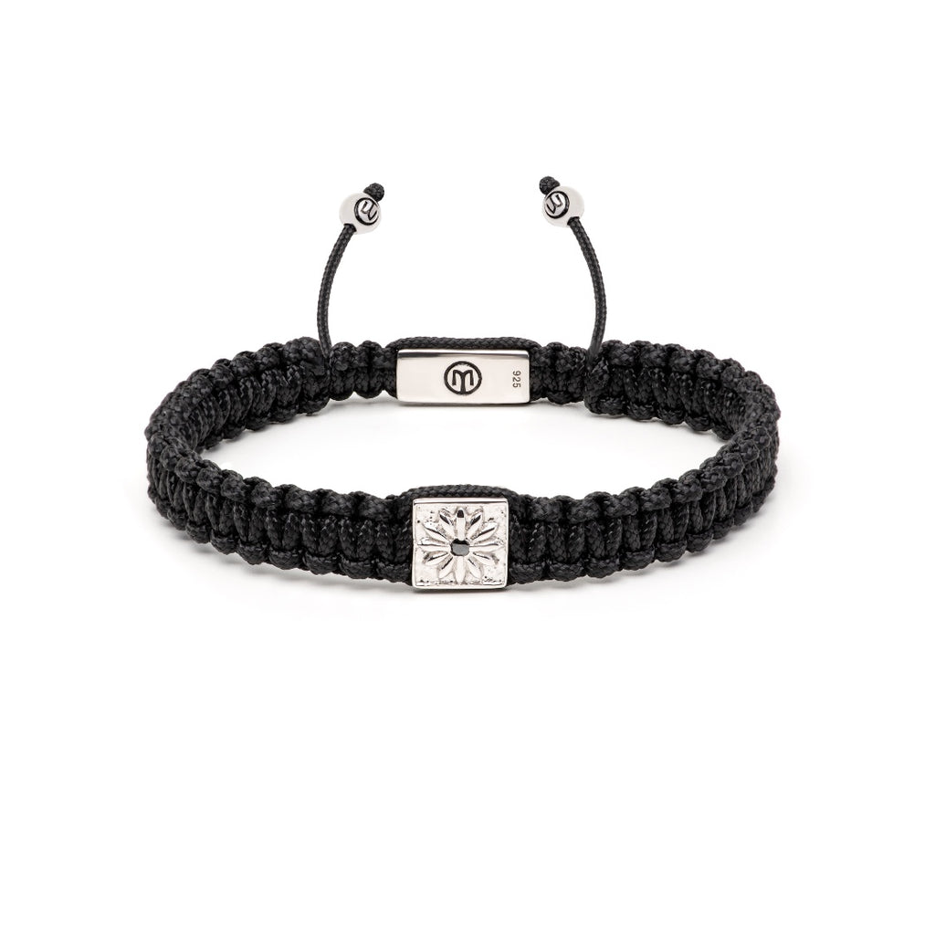 black macrame bracelet with silver square bead and black moissanite on a white background