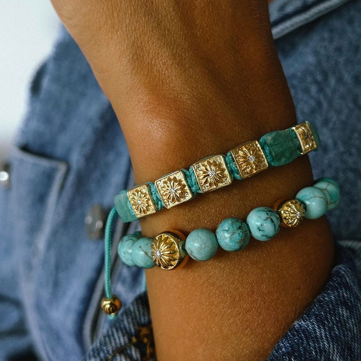 woman with denim outfit wearing turquoise bracelets with gold - the conqueror