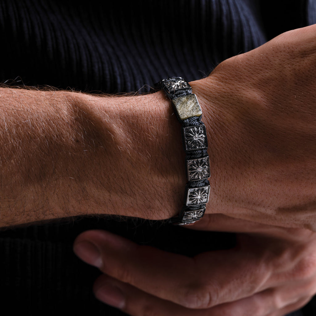 Close-up of a person's wrist wearing a decorative bracelet.