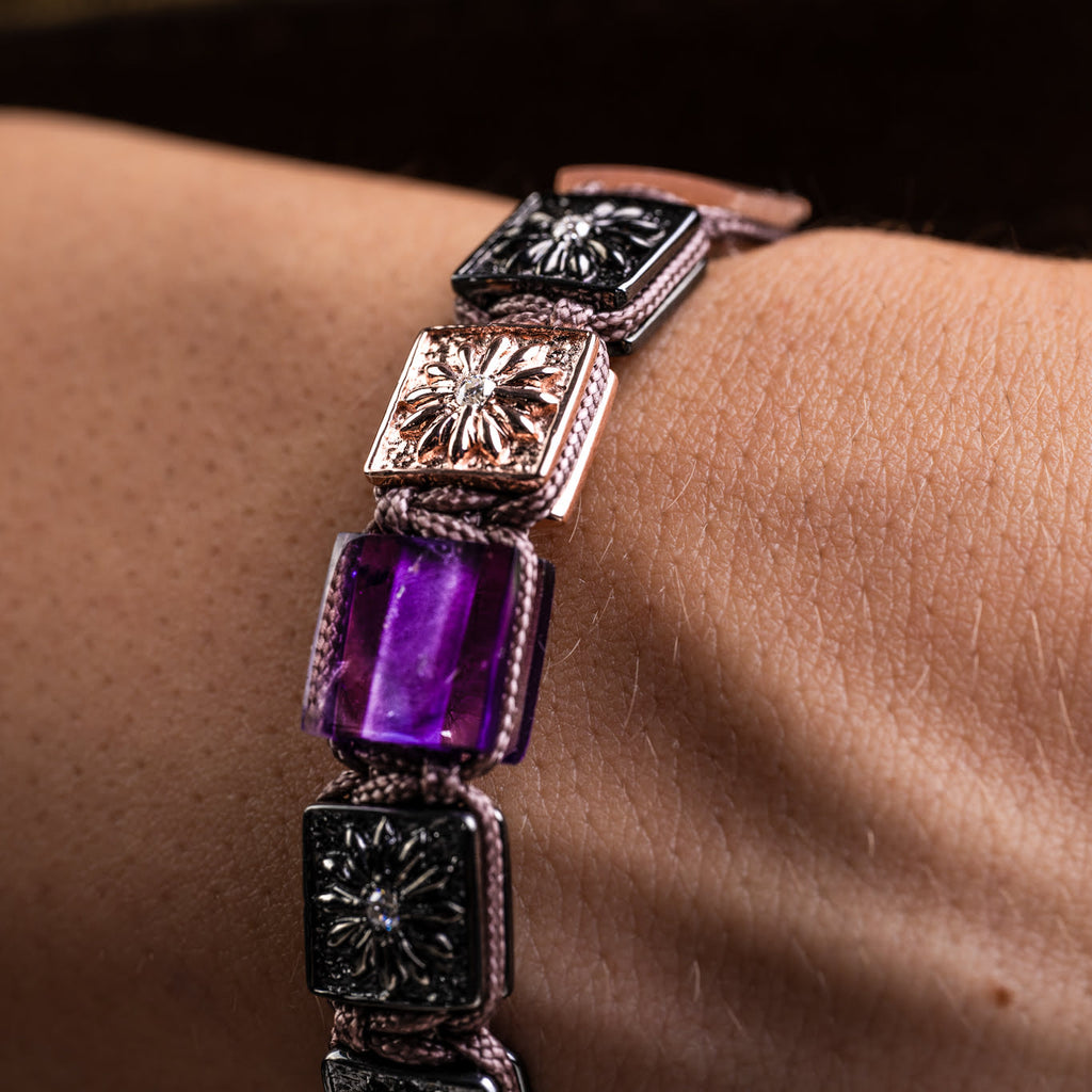 Bracelet with amethyst gemstone and decorative clasp on wrist