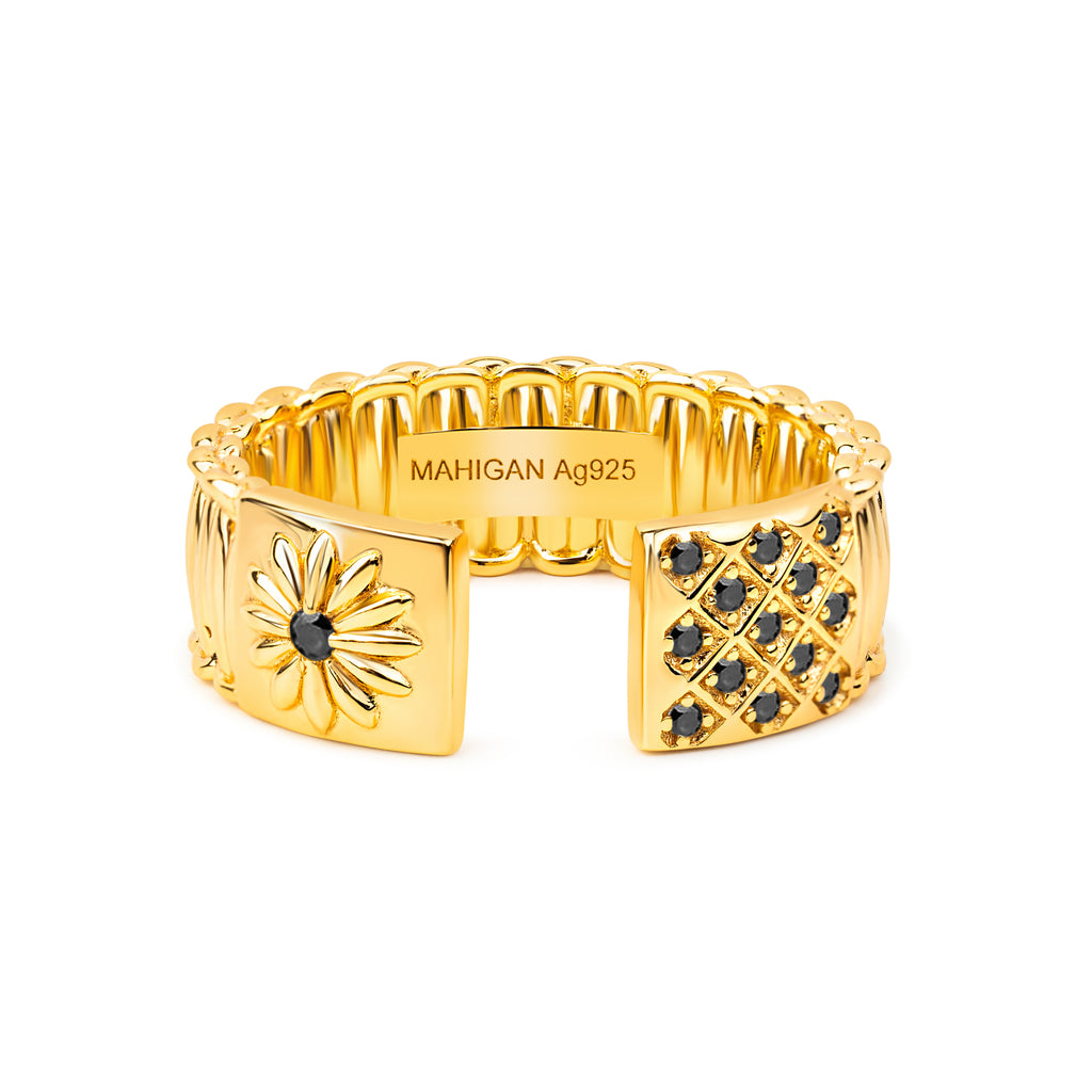 Gold ring with black gemstones on a white background
