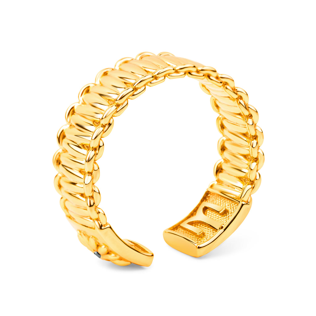 Gold ring with twisted design on a white background