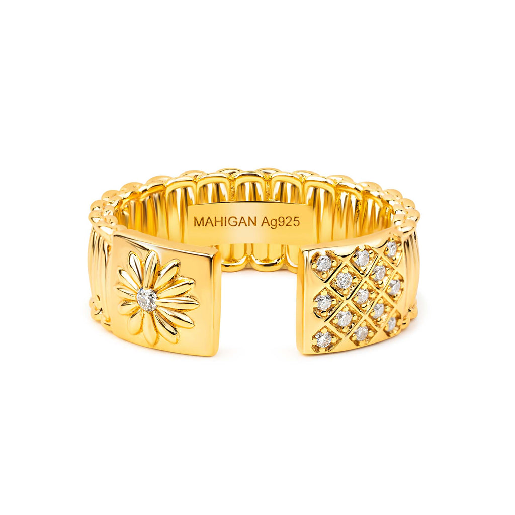 Gold cuff ring with diamond accents on a white background