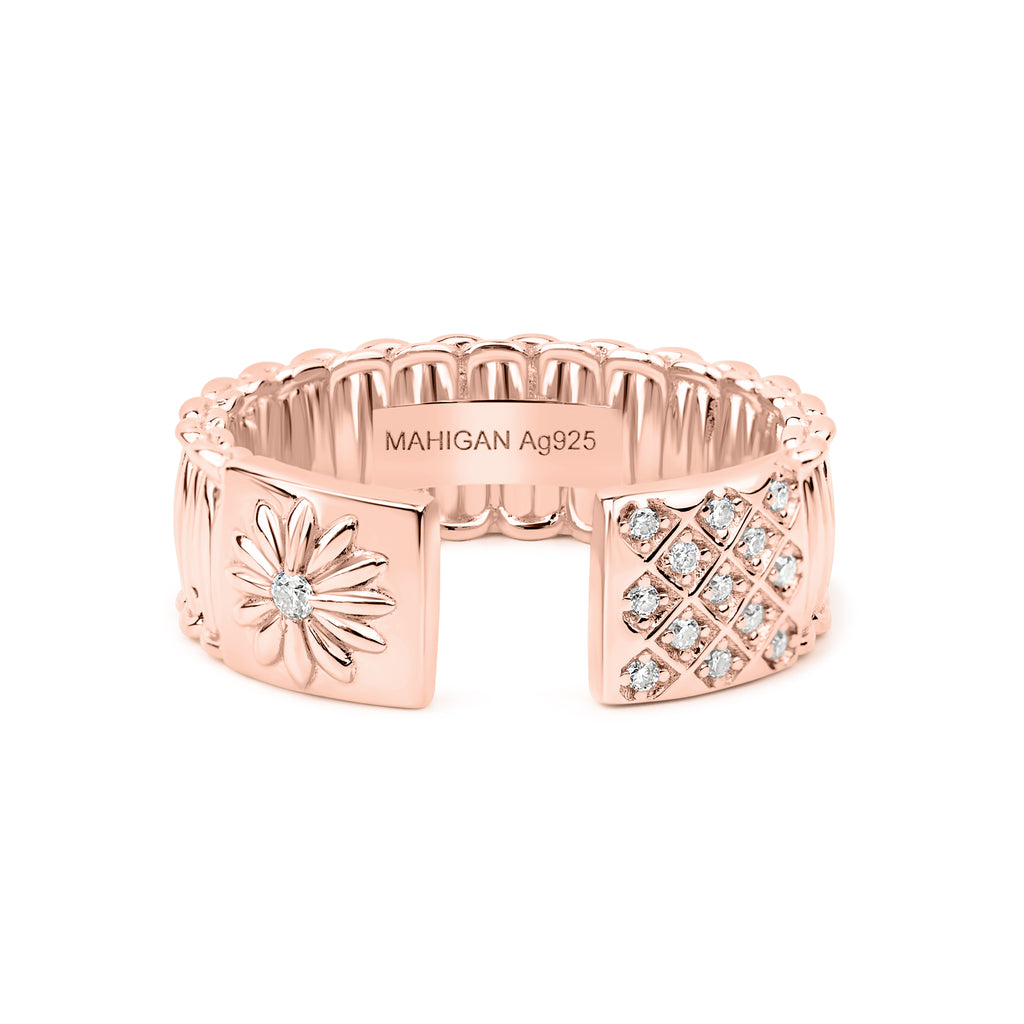 Rose gold ring with floral and geometric designs on a white background