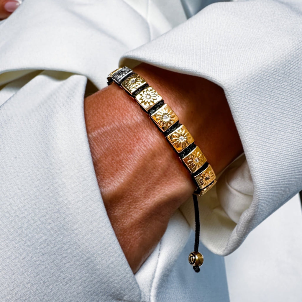 woman wearing gold shamballa bracelet with white moissanites and balck string -the sun worshipper by mahigan jewelry 