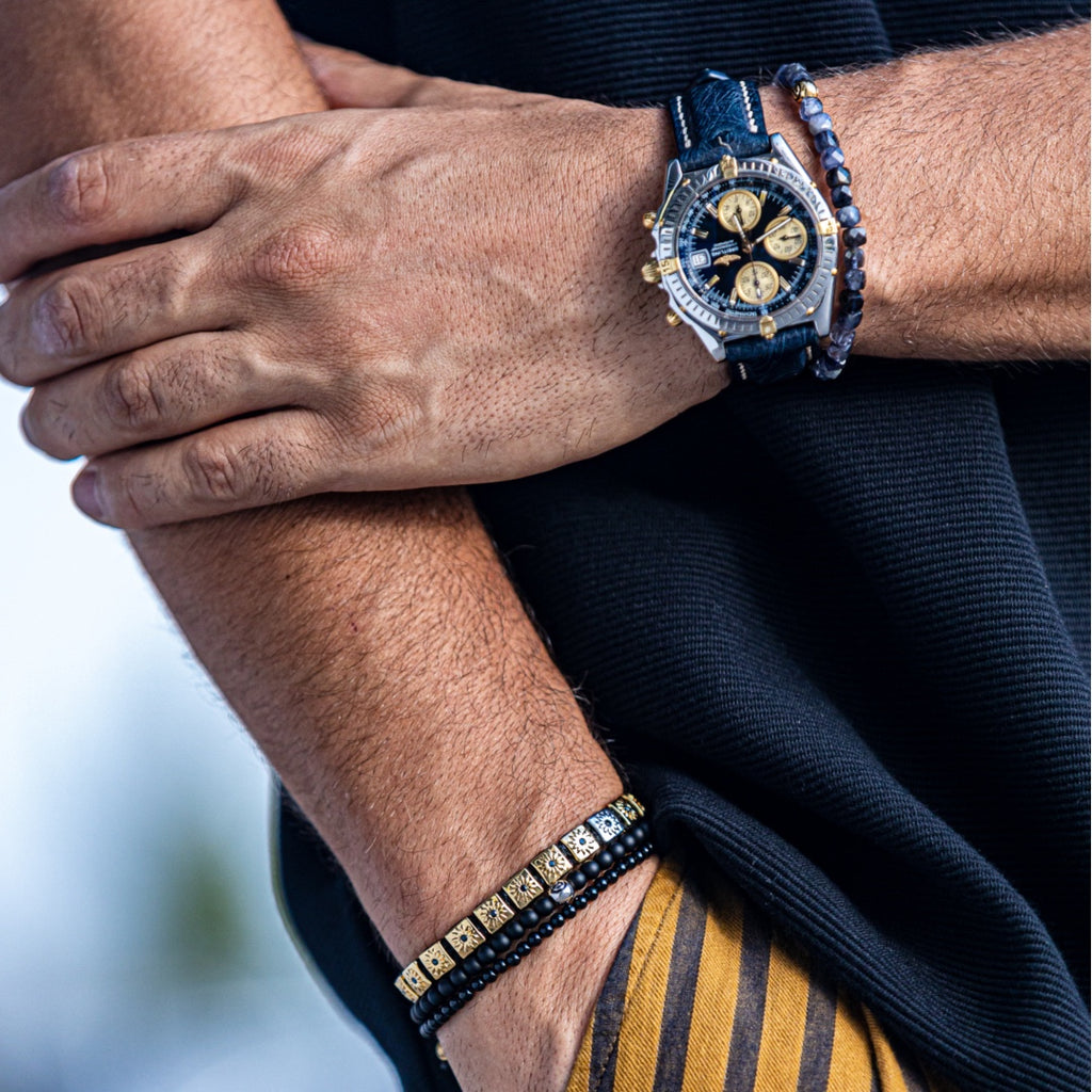 men wearing gold macrame flat-bead bracelet with black string and balck diamonds - the sun worshipper 