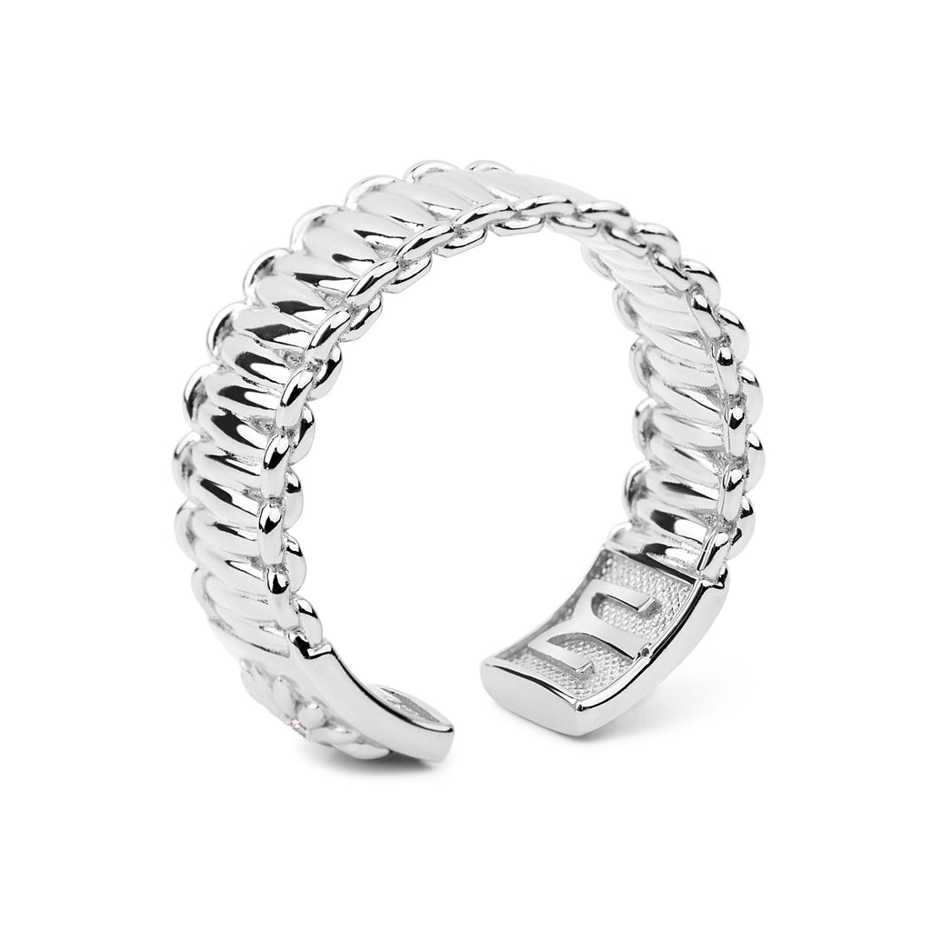 Silver ring with twisted design on a white background